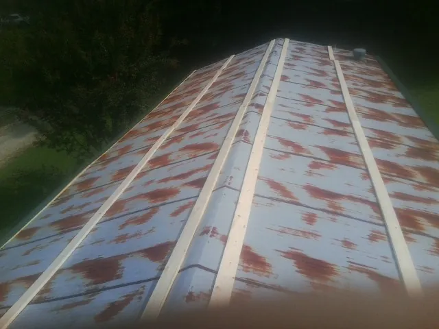 Rusted metal roof panels with new wood purlins before replacement — Storm Damage Roof Repair in Coraopolis by Roofing Brothers